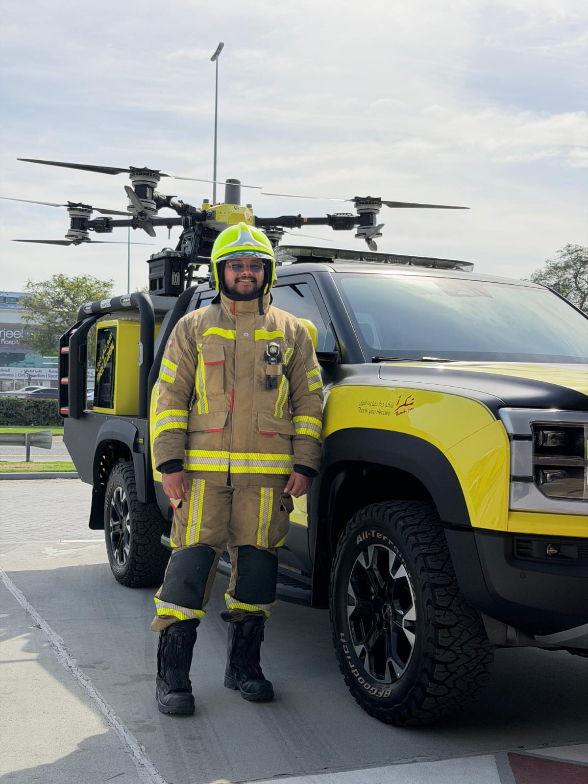 Dubai Civil Defence firefighter in full gear beside a drone-equipped response truck